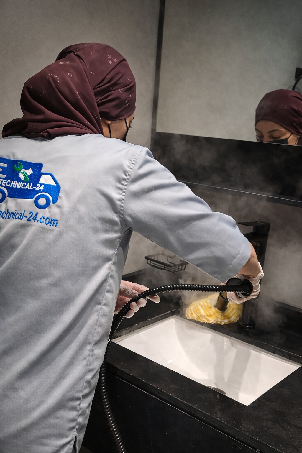 Snow White team member sanitizing a bathroom area